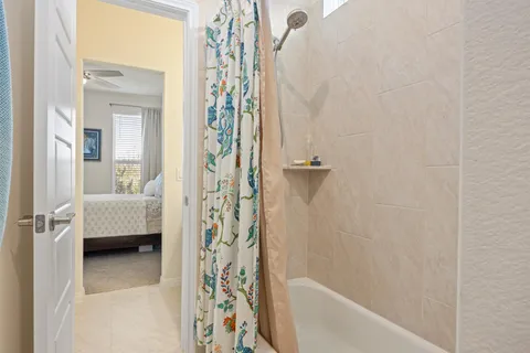a bathroom with a double vanity sink mirror and shower