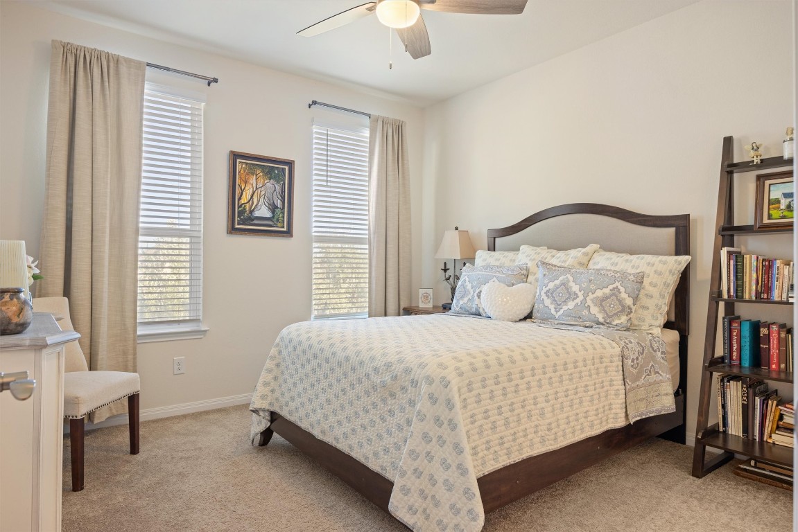 210 Raptor Beak Way Cedar Creek, TX 78612 - Photo 25 of 36 a bedroom with a bed and a book shelf
