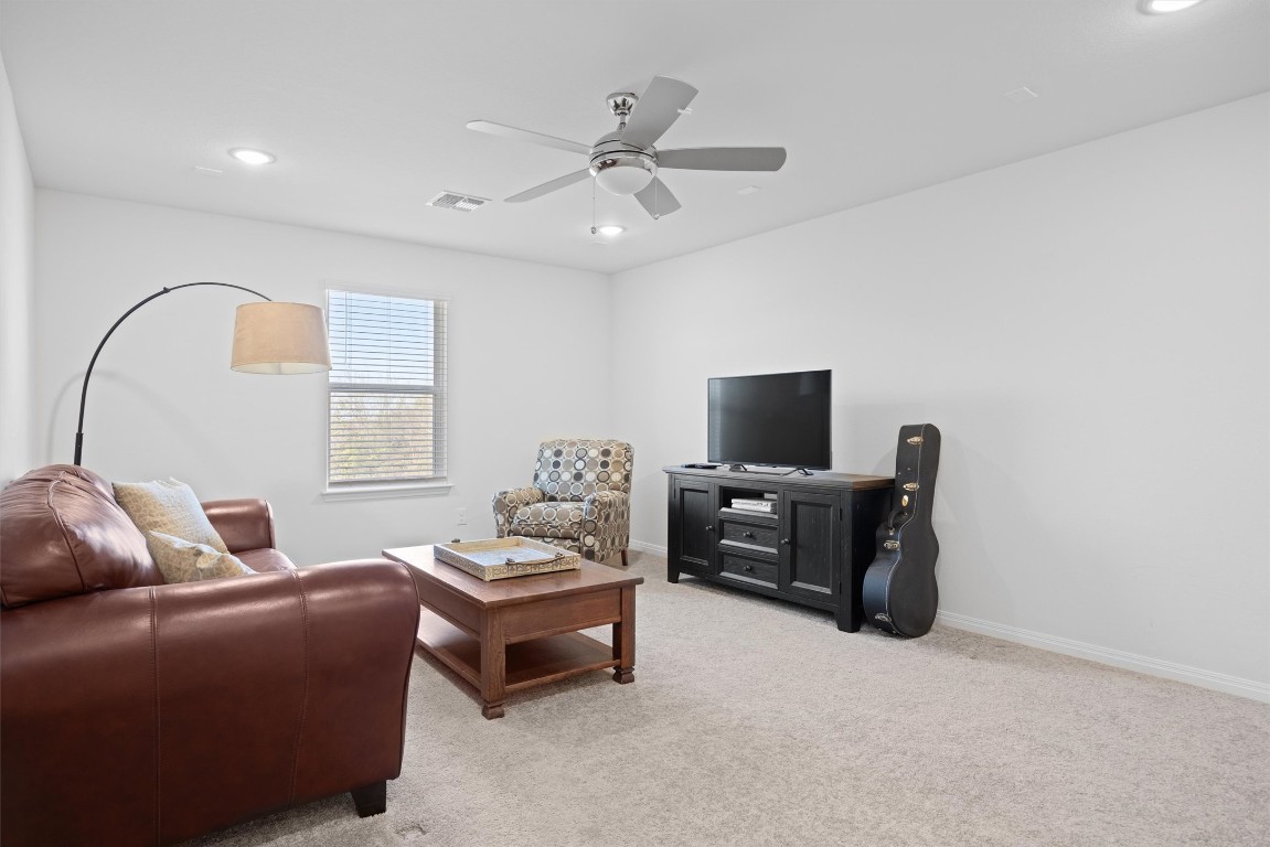 210 Raptor Beak Way Cedar Creek, TX 78612 - Photo 26 of 36 a living room with furniture and a flat screen tv