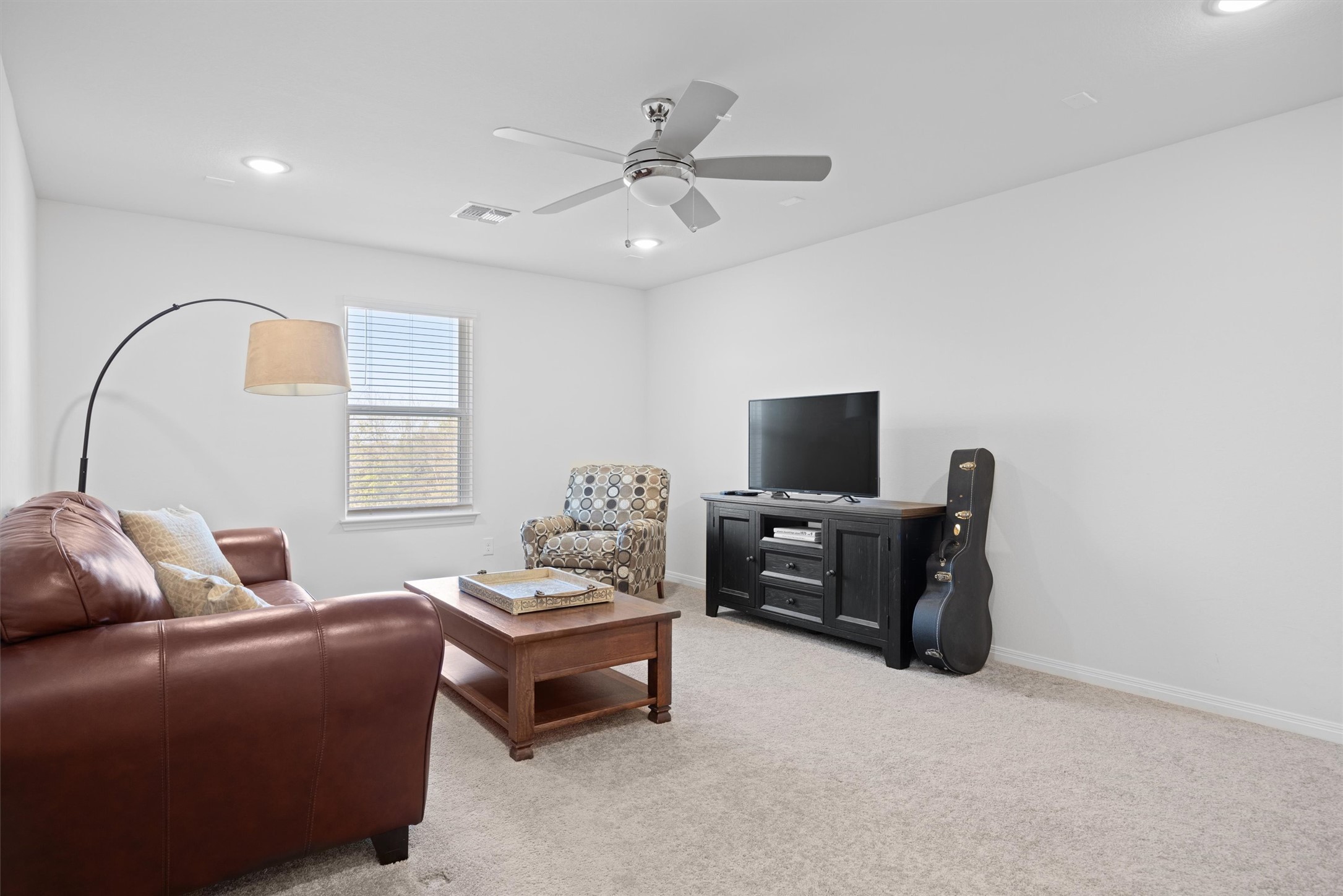 210 Raptor Beak Way Cedar Creek, TX 78612 - Photo 27 of 36 a living room with furniture and a flat screen tv