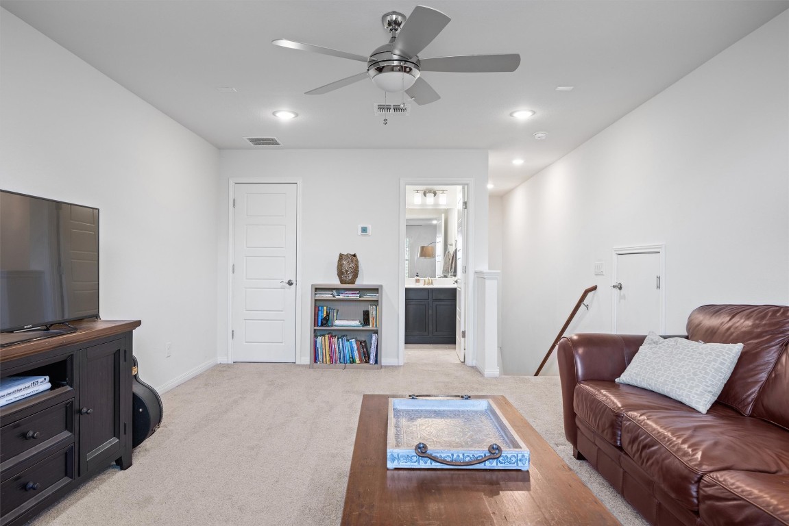 210 Raptor Beak Way Cedar Creek, TX 78612 - Photo 28 of 36 a living room with furniture and a flat screen tv