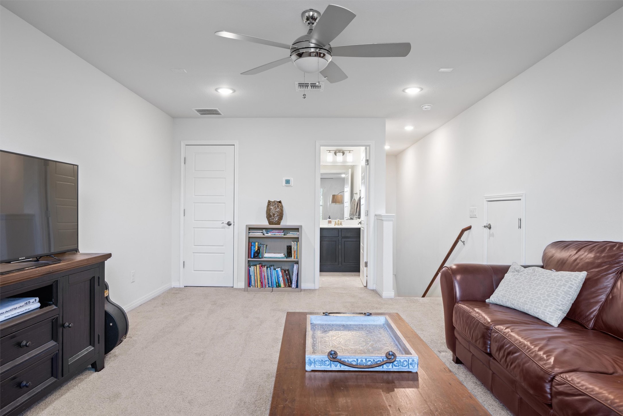 210 Raptor Beak Way Cedar Creek, TX 78612 - Photo 29 of 36 a living room with furniture and a flat screen tv