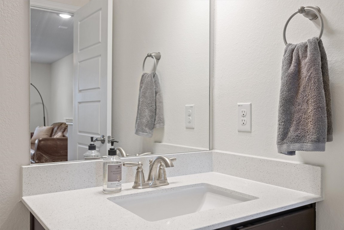 210 Raptor Beak Way Cedar Creek, TX 78612 - Photo 29 of 36 a bathroom with a sink and a mirror
