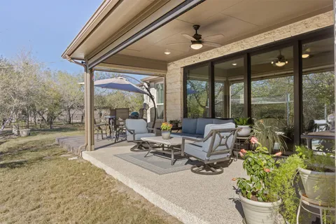 a view of a patio with table and chairs with wooden floor and fence