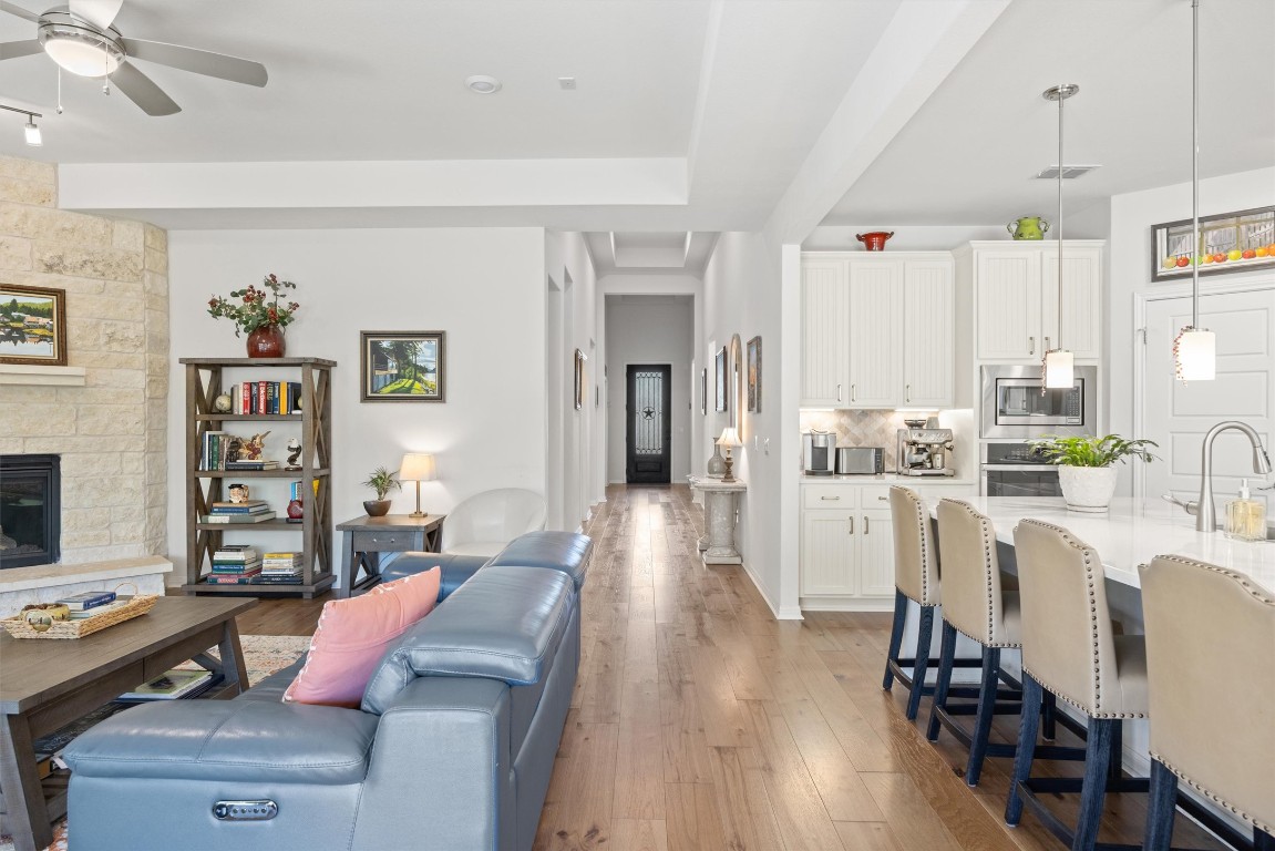 210 Raptor Beak Way Cedar Creek, TX 78612 - Photo 3 of 36 a living room with kitchen island furniture and a wooden floor