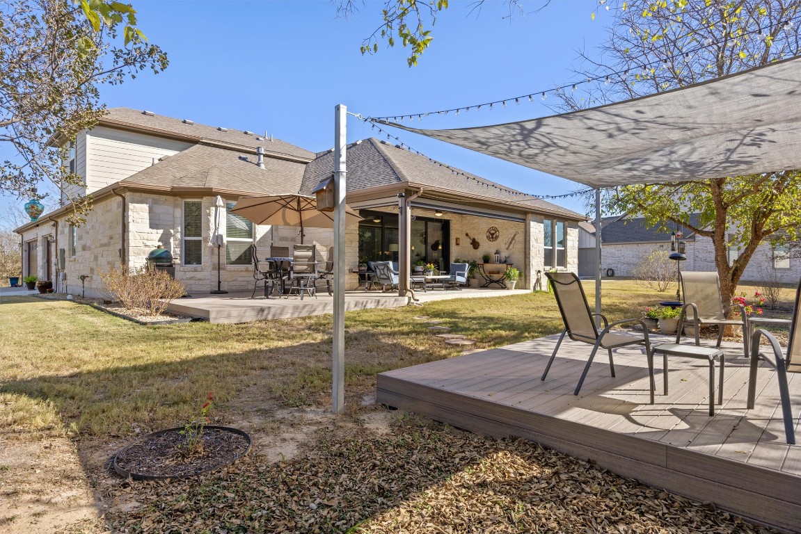 210 Raptor Beak Way Cedar Creek, TX 78612 - Photo 31 of 36 a view of a patio with table and chairs with wooden floor and fence