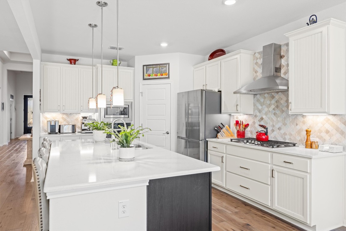 210 Raptor Beak Way Cedar Creek, TX 78612 - Photo 8 of 36 a kitchen with refrigerator and cabinets