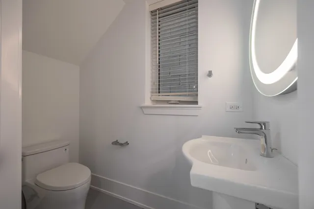 a bathroom with a toilet and a sink