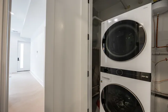 a view of a hallway with washer and dryer