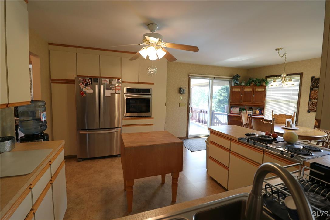 103 James Way Road Bath, PA 18014 - Photo 12 of 50 a kitchen with a refrigerator a stove a sink dishwasher a oven with a dining table and chairs