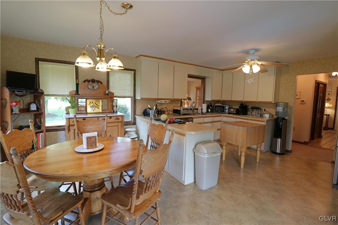 103 James Way Road Bath, PA 18014 - Photo 17 of 50 a dining room with furniture a chandelier a kitchen view and a chandelier