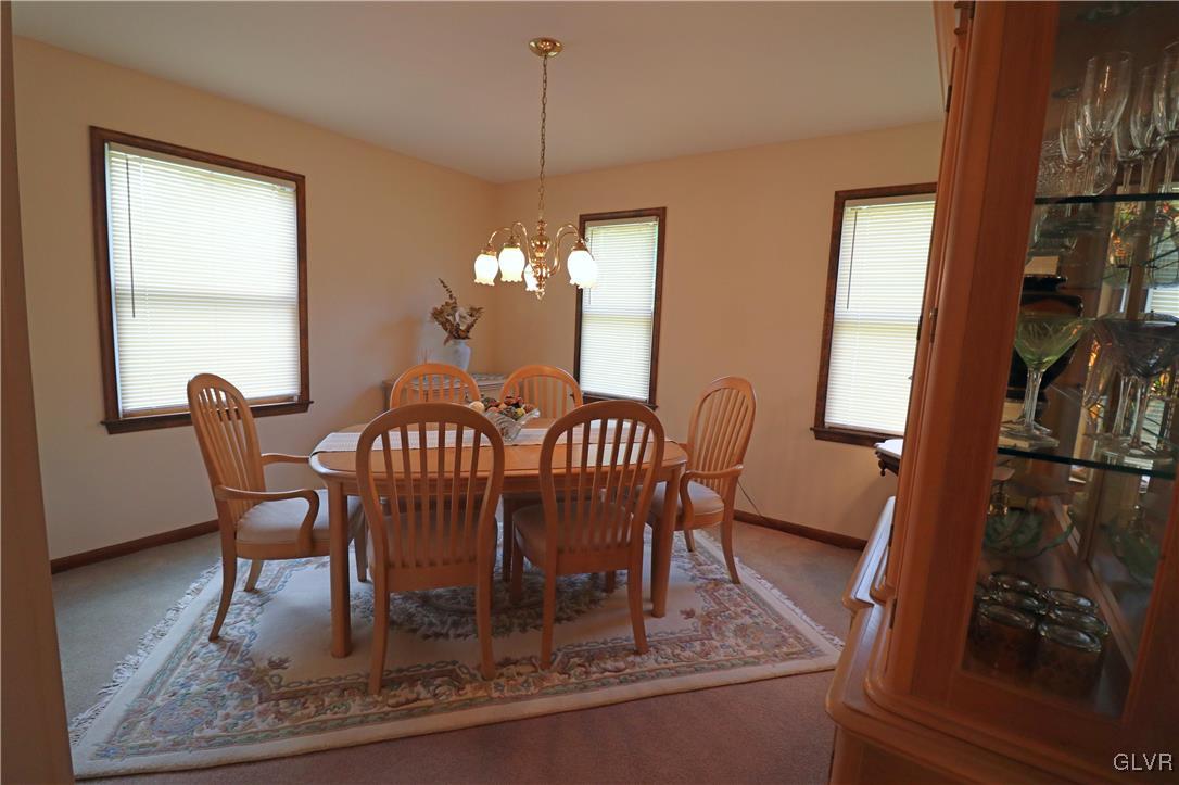 103 James Way Road Bath, PA 18014 - Photo 10 of 50 a dining room with furniture a rug and a chandelier