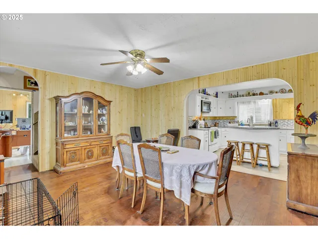 a view of a dining room with furniture and chandelier