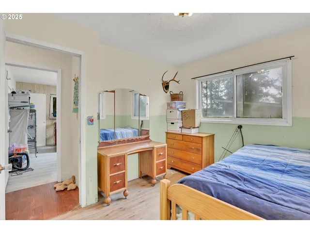 a bedroom with a bed and a dresser