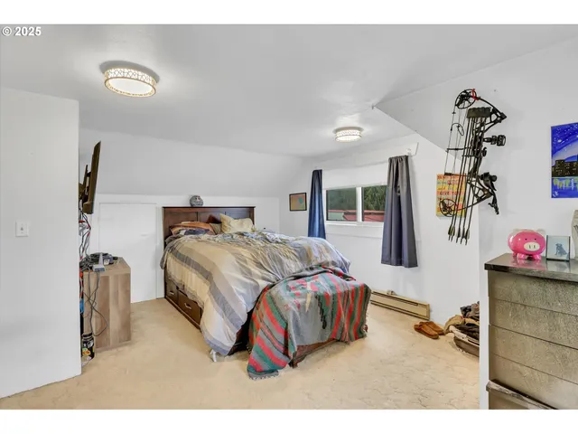 a bedroom with a bed and a dresser