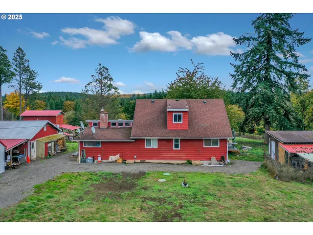 a view of house with backyard