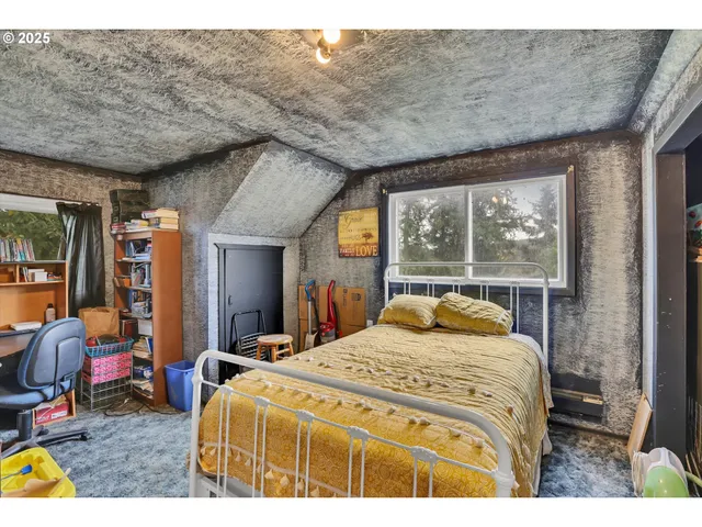 a bed sitting in a bedroom next to a window