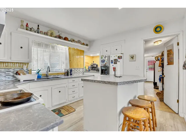 a kitchen with stainless steel appliances granite countertop a sink and cabinets