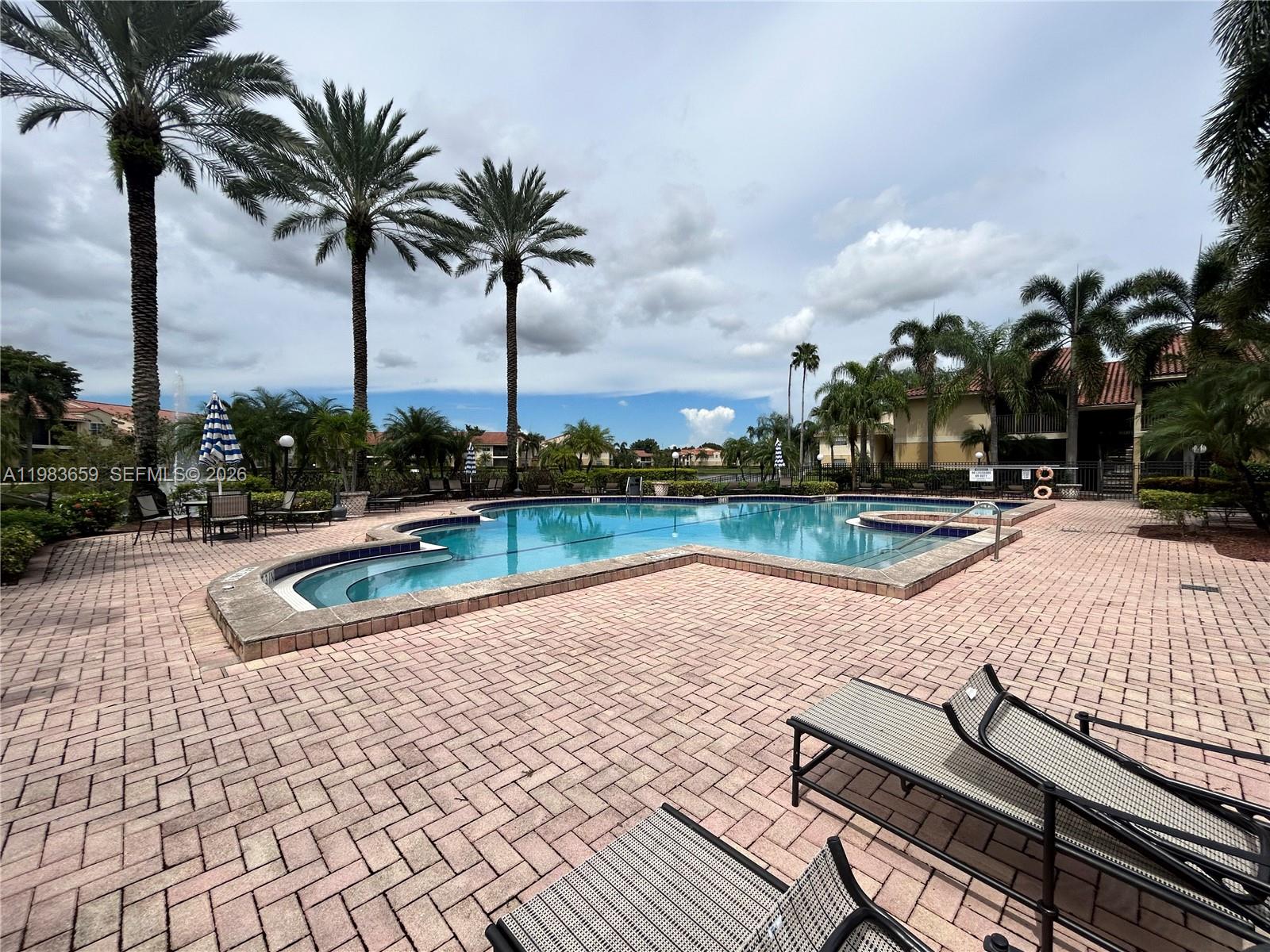 1263 Southwest 46th Avenue, Unit 2109 Pompano Beach, FL 33069 - Photo 13 of 18 a view of swimming pool with chairs