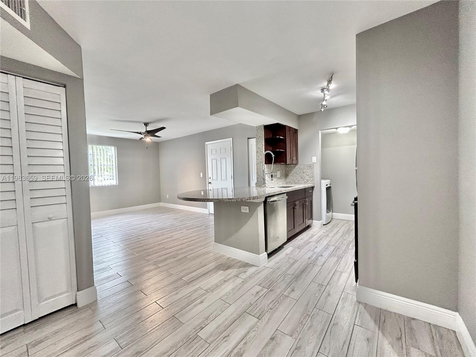 1263 Southwest 46th Avenue, Unit 2109 Pompano Beach, FL 33069 - Photo 4 of 18 a view of kitchen with wooden floor