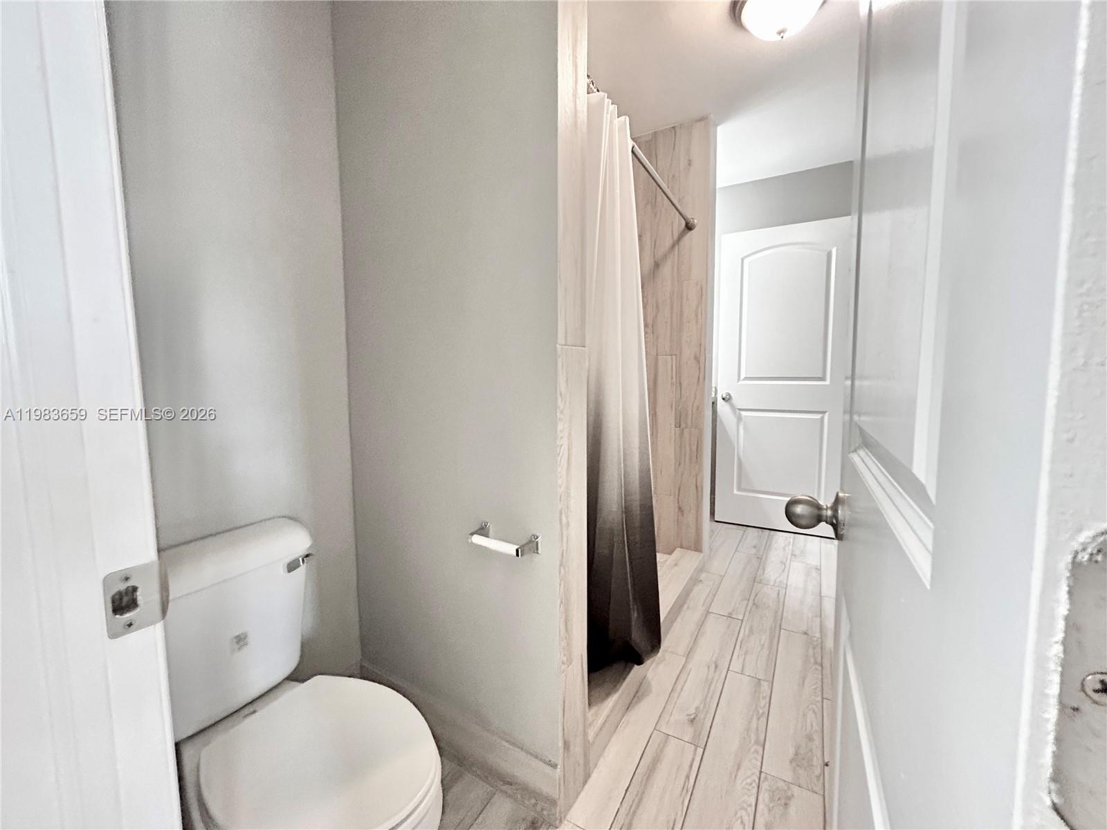 1263 Southwest 46th Avenue, Unit 2109 Pompano Beach, FL 33069 - Photo 6 of 18 a bathroom with a toilet and a shower