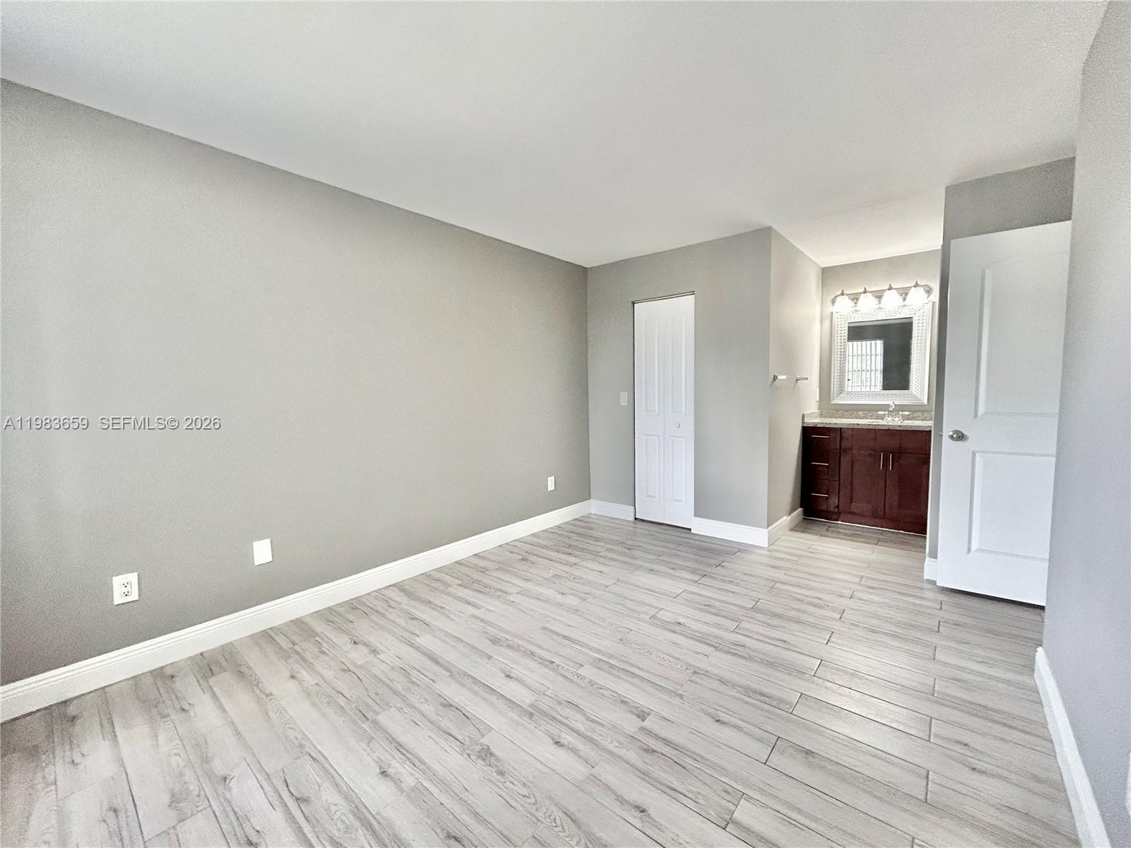1263 Southwest 46th Avenue, Unit 2109 Pompano Beach, FL 33069 - Photo 7 of 18 a view of empty room with wooden floor and kitchen