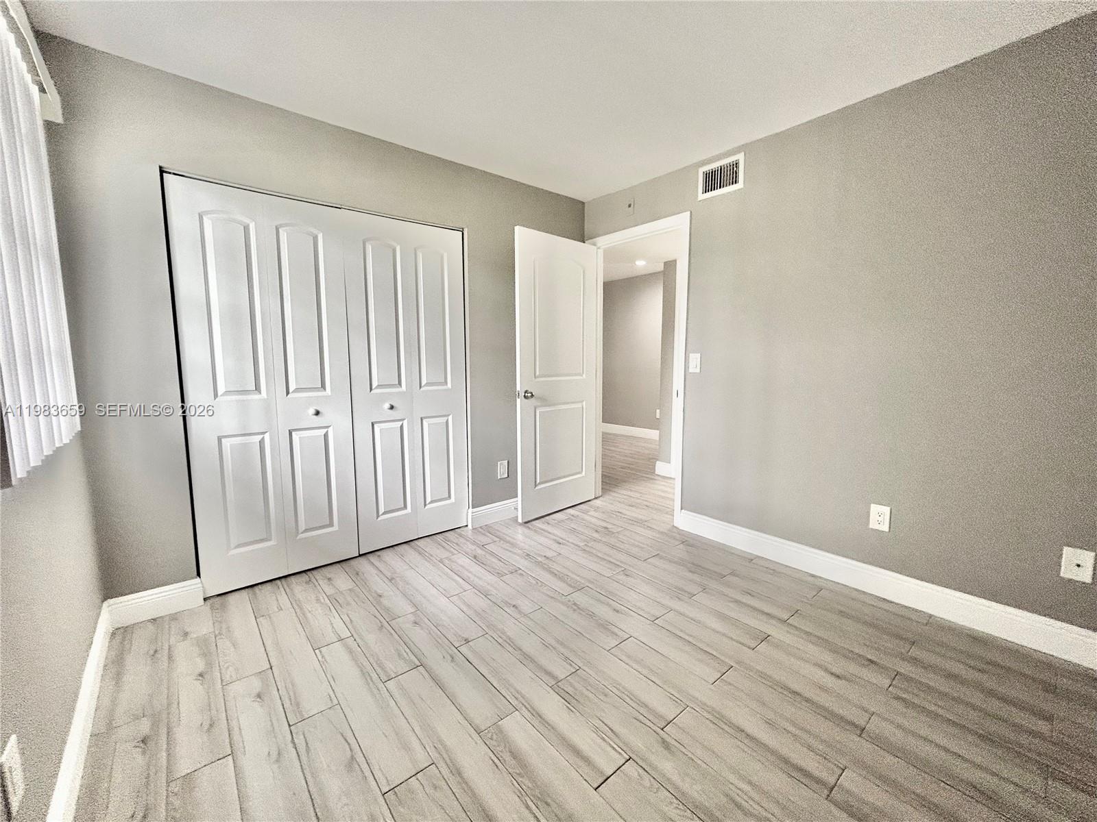 1263 Southwest 46th Avenue, Unit 2109 Pompano Beach, FL 33069 - Photo 8 of 18 a view of empty room with wooden floor