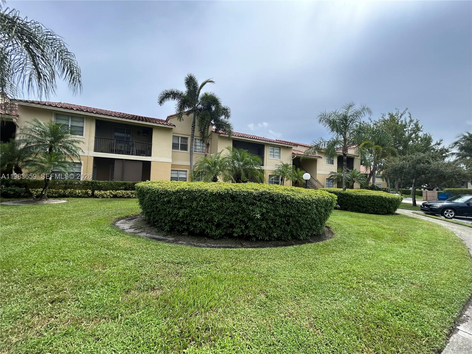 1263 Southwest 46th Avenue, Unit 2109 Pompano Beach, FL 33069 - Photo 10 of 18 a front view of a house with a yard