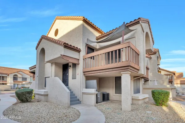 a view of a white building among the front of a house