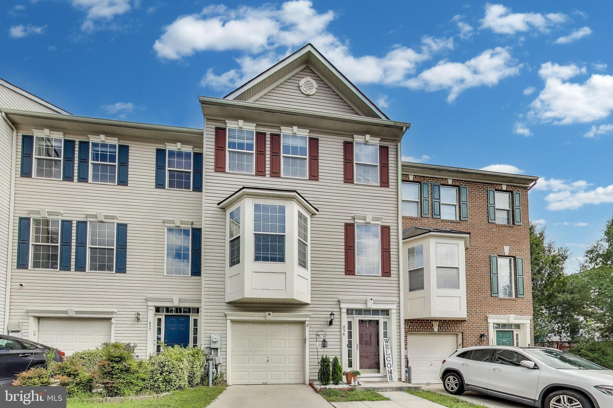 a front view of a residential apartment building with a yard