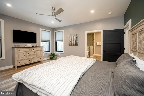 a bedroom with a bed and a flat screen tv