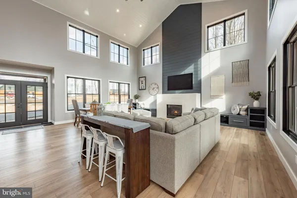 a dining room with furniture a window and wooden floor