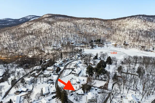 an aerial view of a house with yard and garage