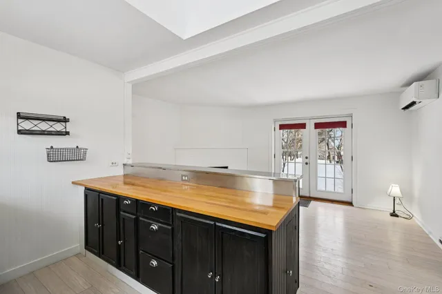 a room with a sink and a wooden floor