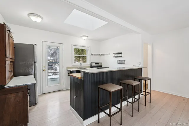 a kitchen with a table chairs refrigerator and cabinets