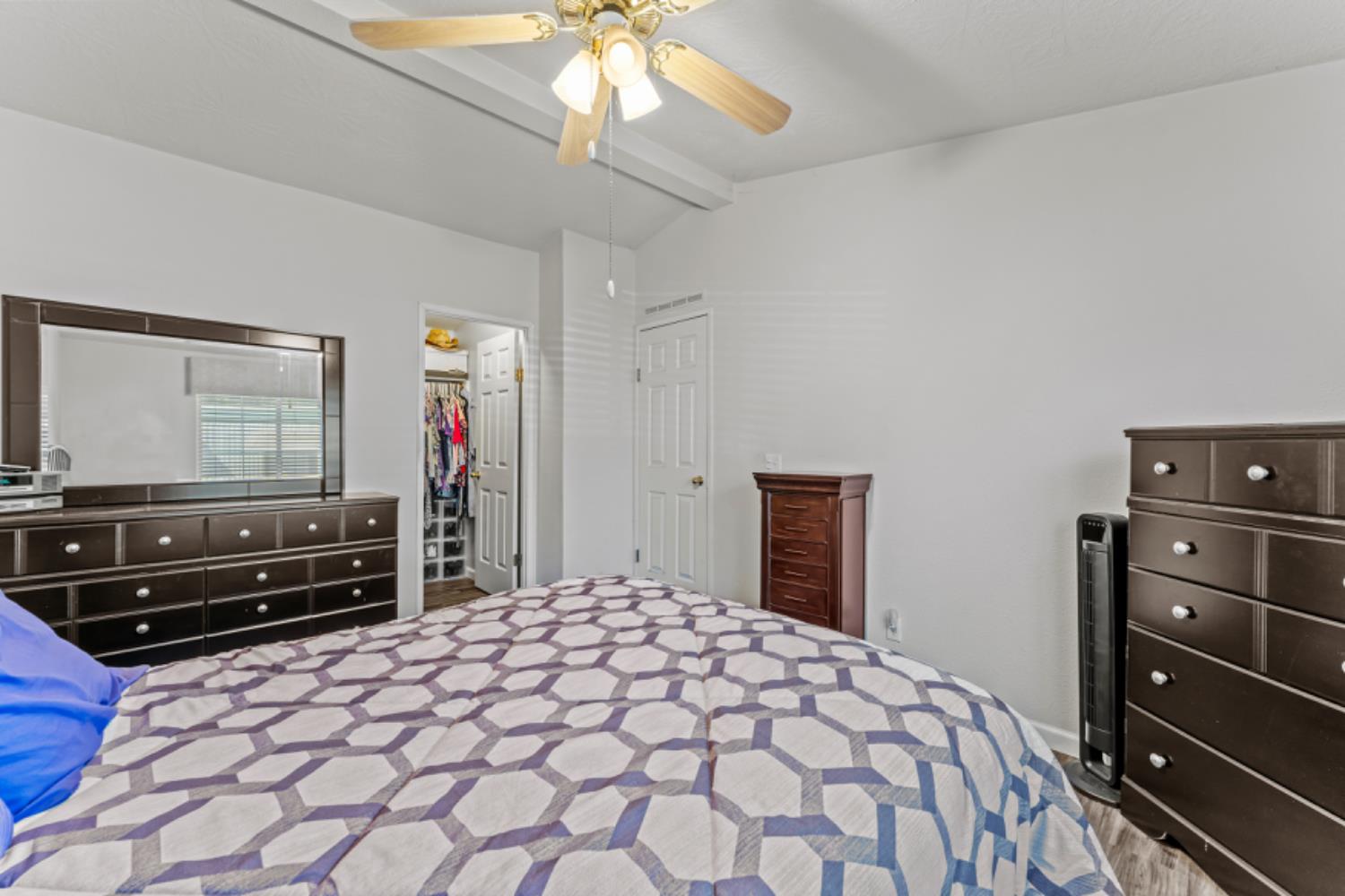 96 Monterey Lane Folsom, CA 95630 - Photo 14 of 27 a bedroom with a bed and a chandelier