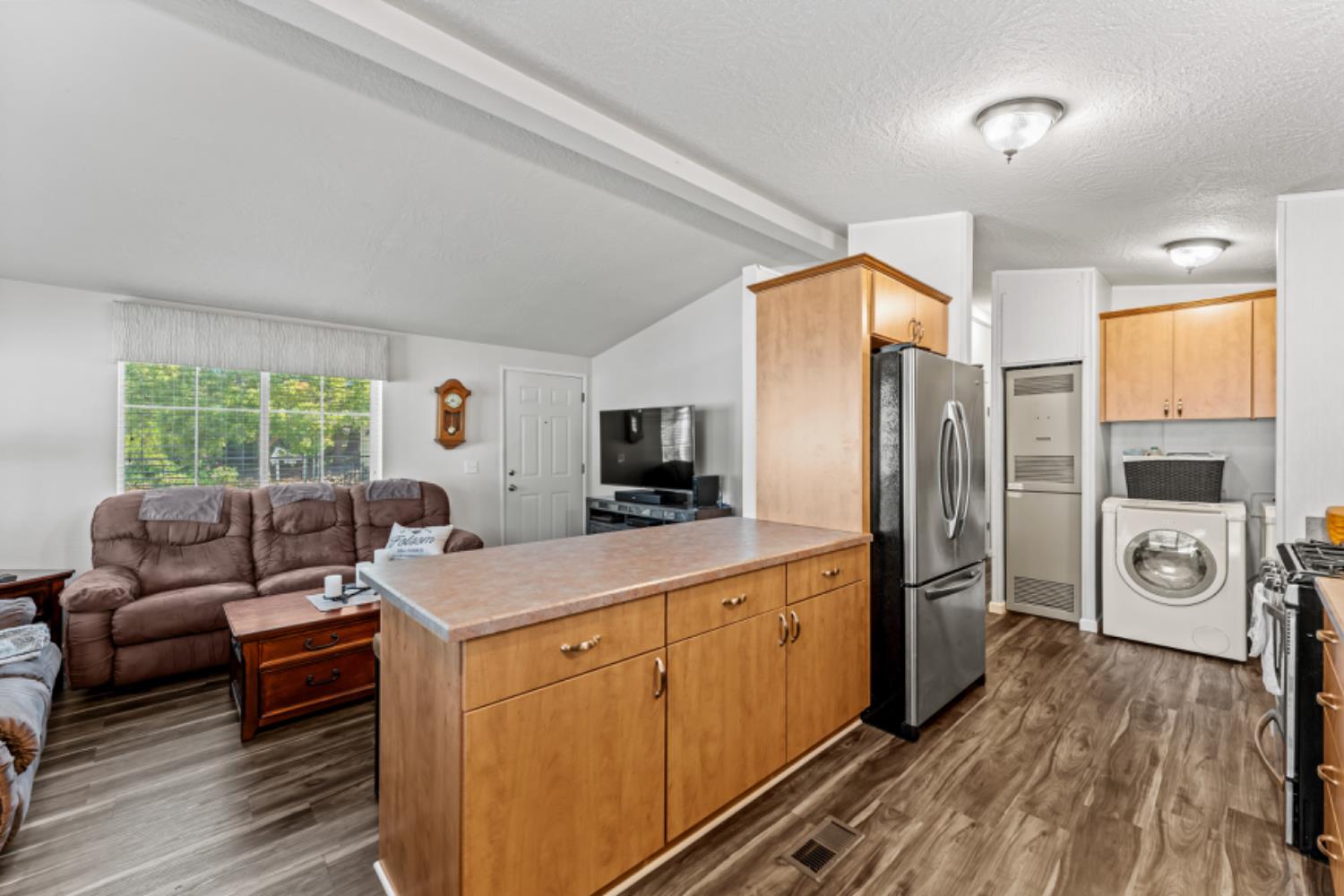 96 Monterey Lane Folsom, CA 95630 - Photo 4 of 27 a living room with furniture a flat screen tv and a refrigerator