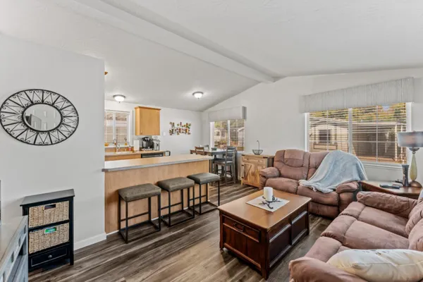 a living room with furniture a table and a large window