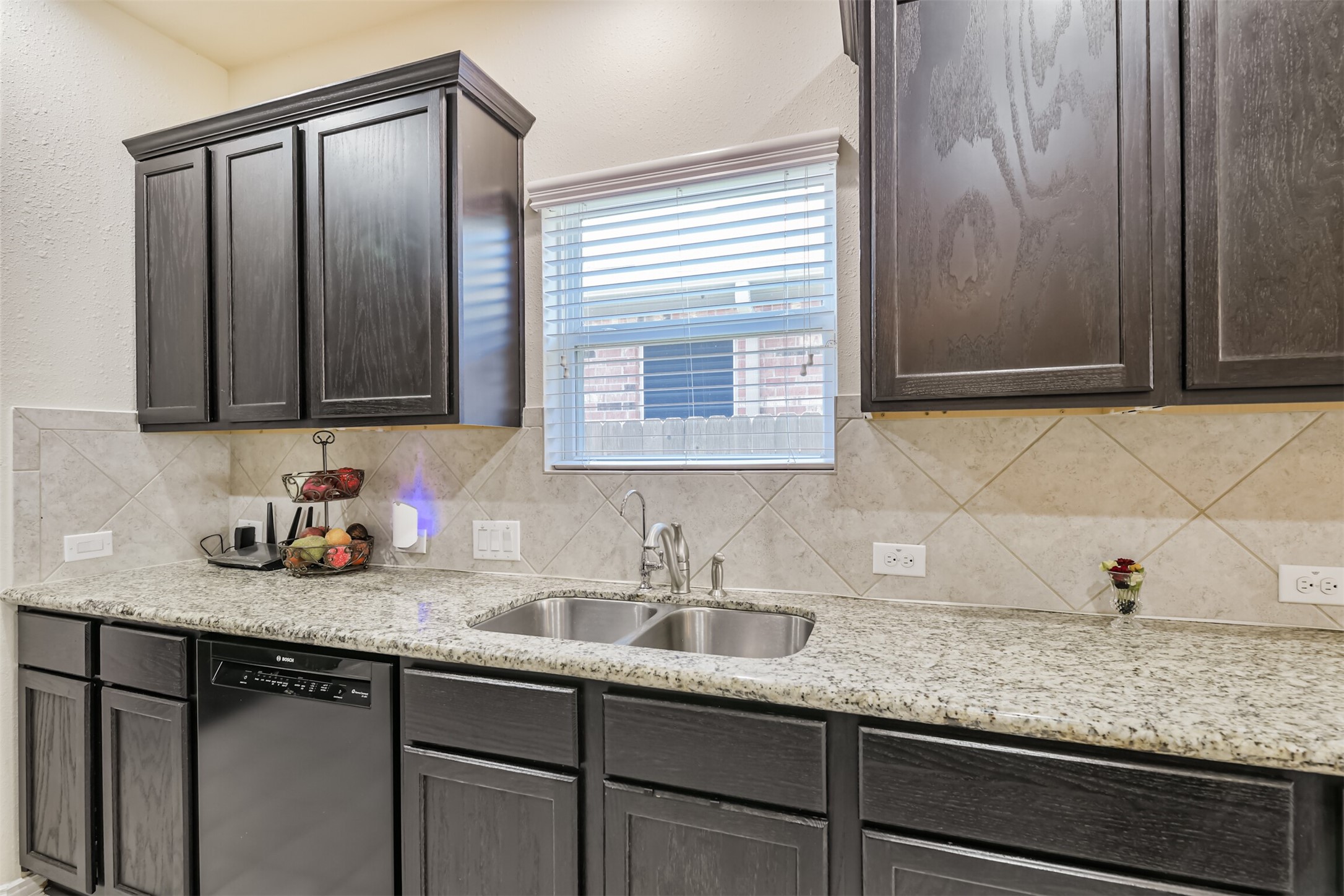 7527 Windsor Valley Lane Houston, TX 77049 - Photo 20 of 35 a kitchen with granite countertop cabinets sink and window