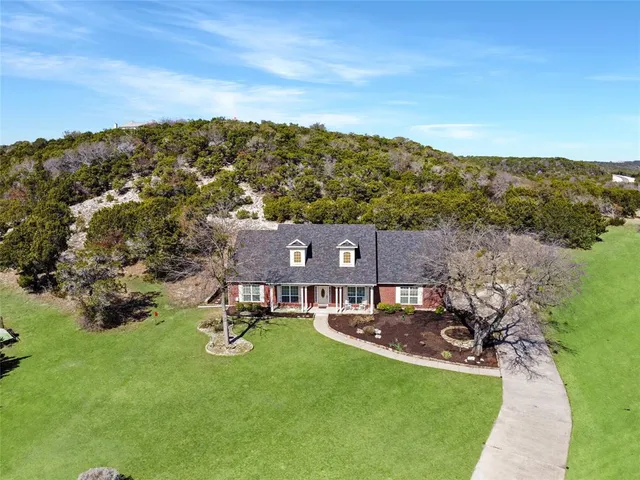 an aerial view of a house with yard