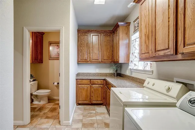 a utility room with sink dryer and washer