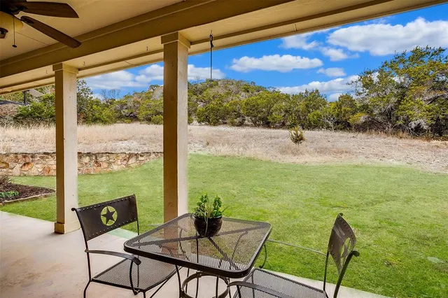 a view of a chairs and table in patio