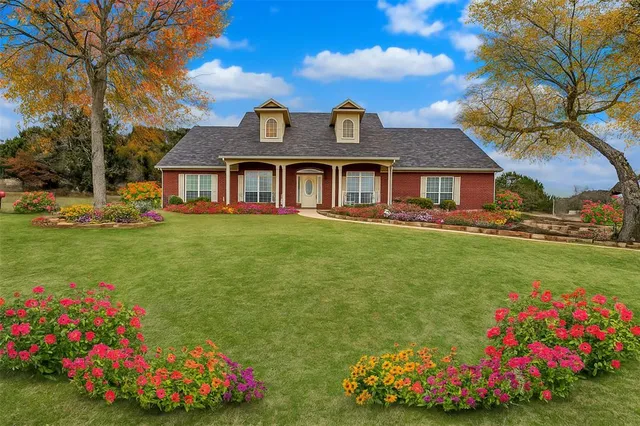a front view of house with yard and trees