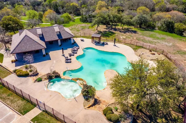 an aerial view of a house with a yard basket ball court and outdoor seating