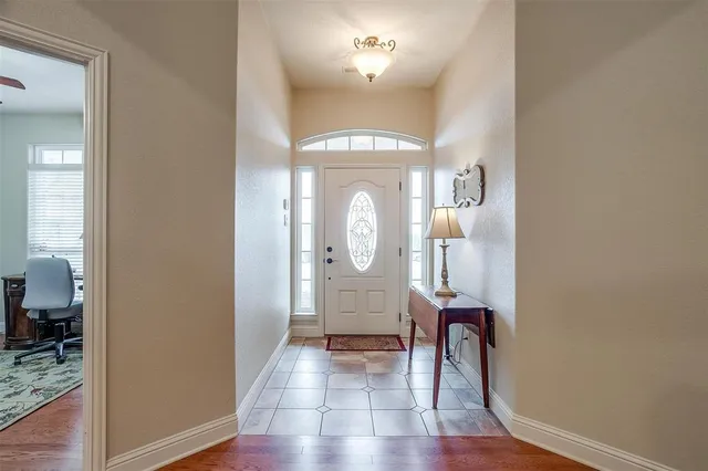 a view of a hallway with wooden floor fireplace and living room