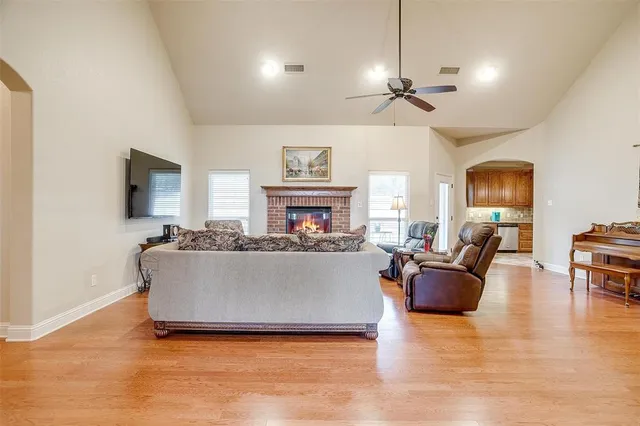 a living room with furniture a fireplace and a flat screen tv