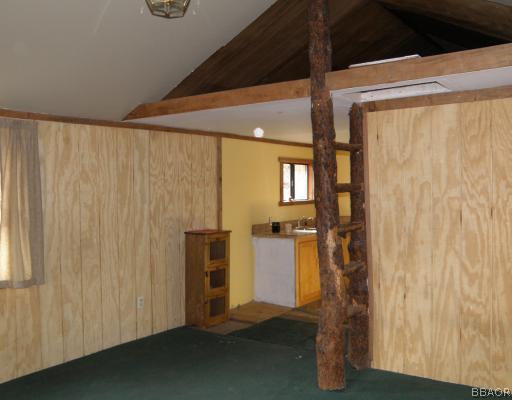 536 Riverside Avenue Sugarloaf, CA 92386 - Photo 3 of 12 Living Room. The rustic "tree ladder" leads to a storagel loft above the living room.