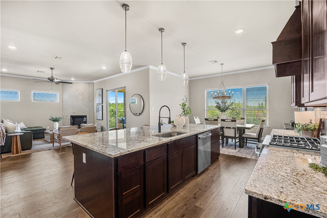 2136 Oak Draw Court Belton, TX 76513 - Photo 5 of 46 a kitchen with granite countertop a sink stove and wooden floor