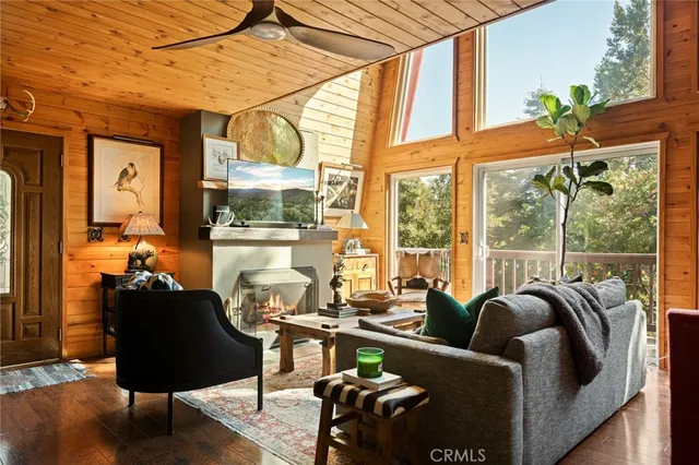 a living room with furniture and floor to ceiling windows