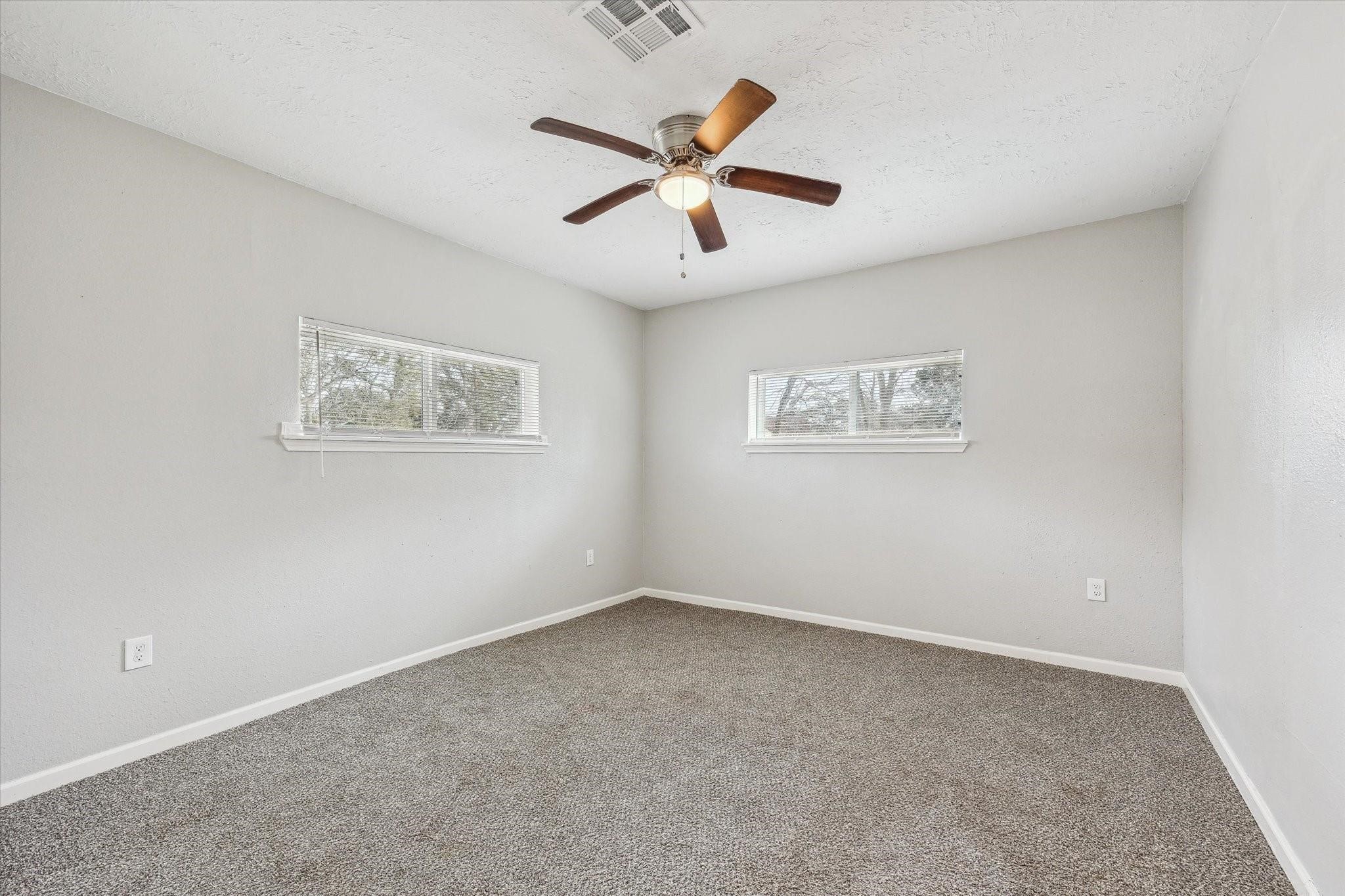 710 East Magnolia Street Angleton, TX 77515 - Photo 7 of 9 a view of an empty room with ceiling fan